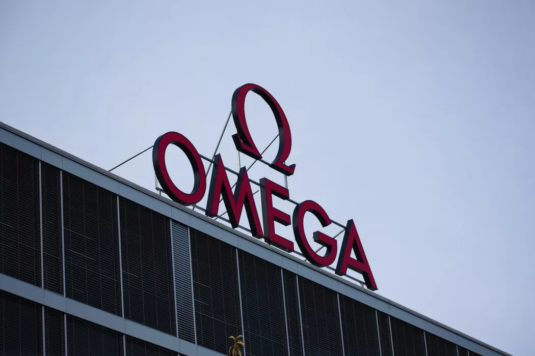 A Sign On Top Of A Building That Reads 'Omega'